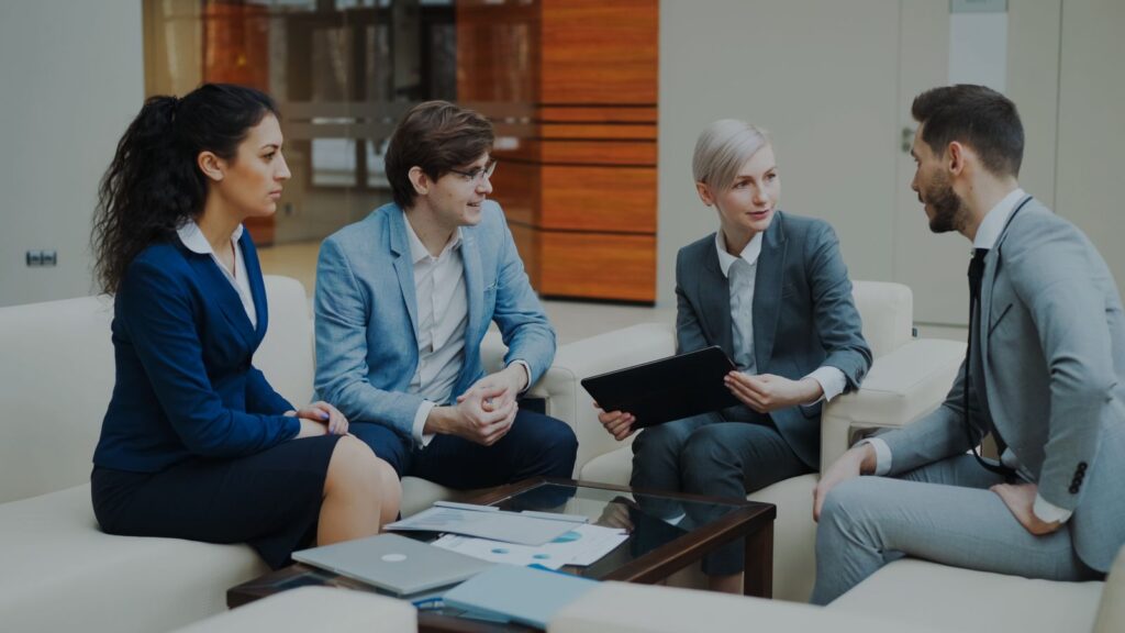 Professionals meeting in a modern office, representing HR outsourcing and employer of record services