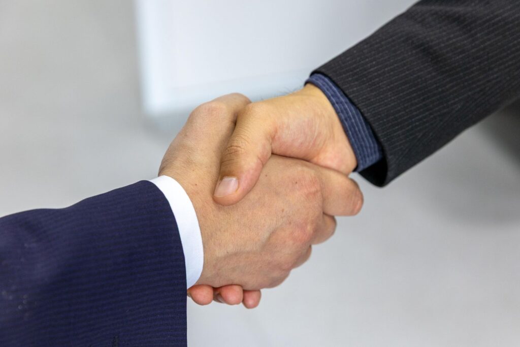 Business handshake closing a company registration engagement with AQQOUNT