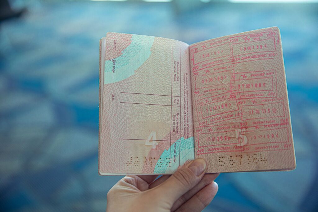 Passport with visa stamps, representing the immigration status needed alongside a Laos work permit