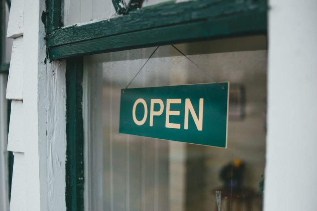 An open sign representing local authorization to operate under a business license